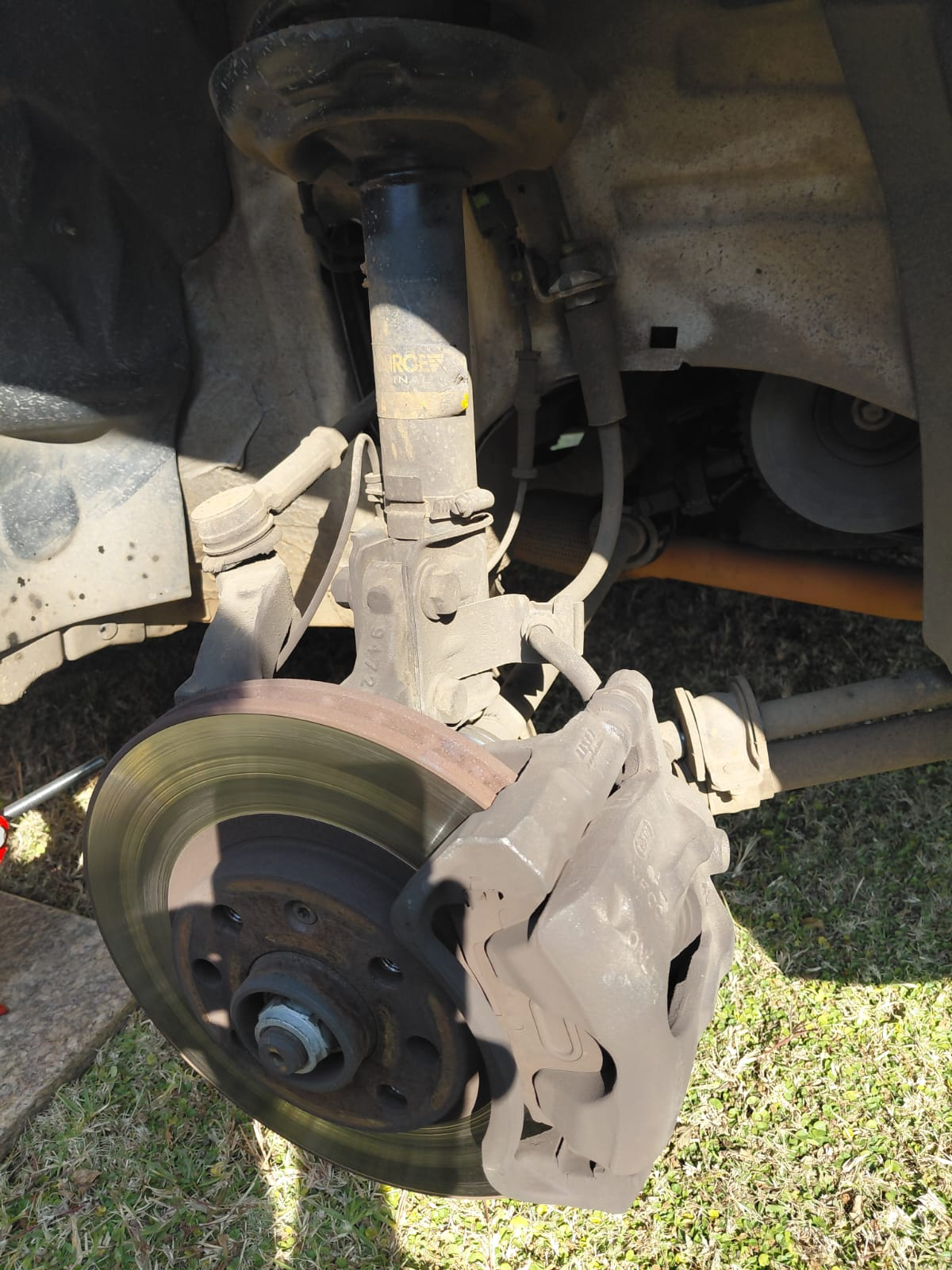 Industrial brake assembly before cleaning, covered in grime